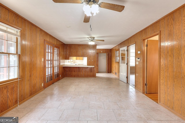 kitchen featuring kitchen peninsula and wood walls