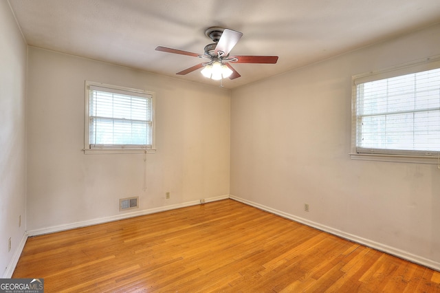 spare room featuring ceiling fan and light hardwood / wood-style flooring