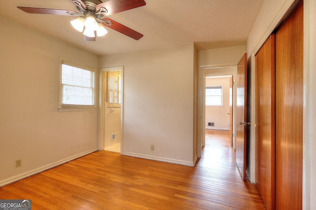 unfurnished bedroom with a closet and light hardwood / wood-style flooring