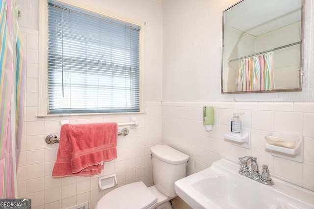 bathroom with sink, a shower with curtain, and toilet