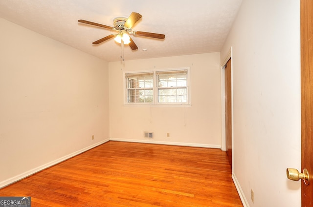 unfurnished room with ceiling fan and light wood-type flooring