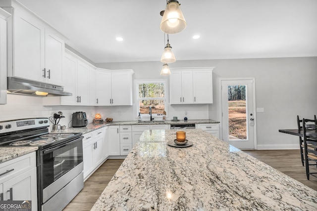 kitchen featuring hanging light fixtures, stainless steel range with electric cooktop, white cabinets, and light stone countertops