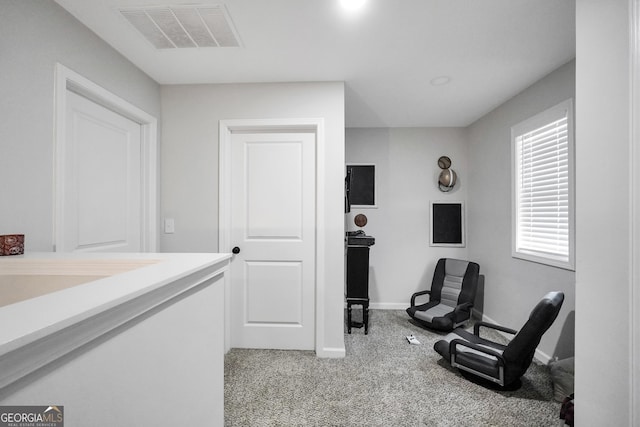 living area with light carpet