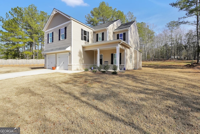 view of front of property with a garage, a porch, and a front lawn