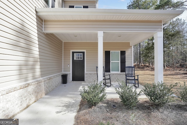 doorway to property featuring covered porch