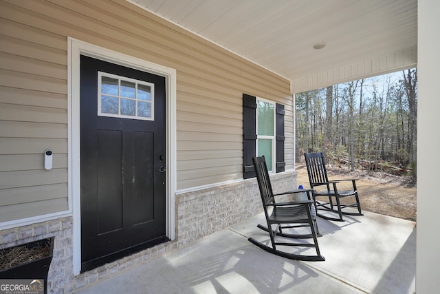 view of exterior entry with a porch