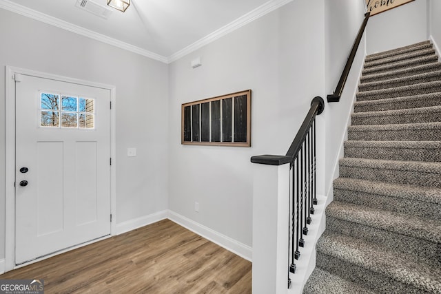 foyer with crown molding and hardwood / wood-style flooring