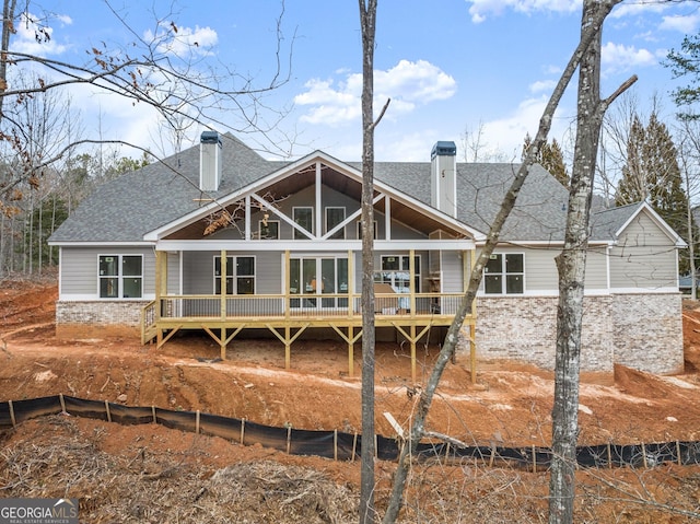 back of house featuring a wooden deck