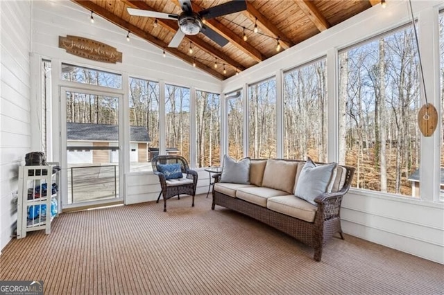 sunroom / solarium featuring ceiling fan, vaulted ceiling with beams, and wood ceiling