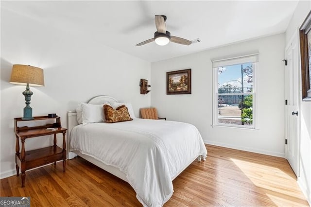 bedroom featuring hardwood / wood-style flooring and ceiling fan