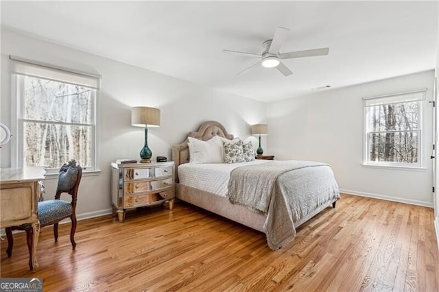 bedroom with ceiling fan and light hardwood / wood-style flooring