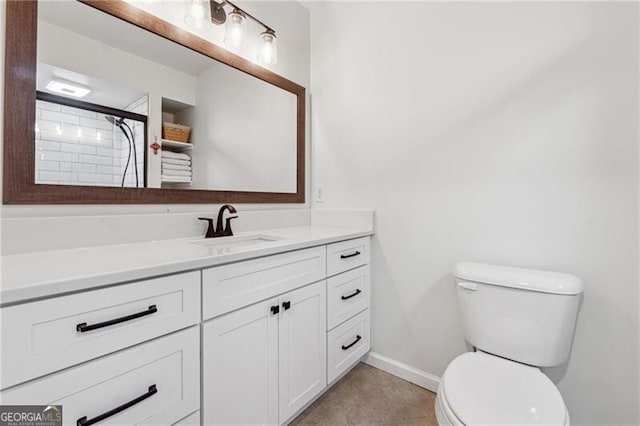 bathroom with vanity, walk in shower, and toilet