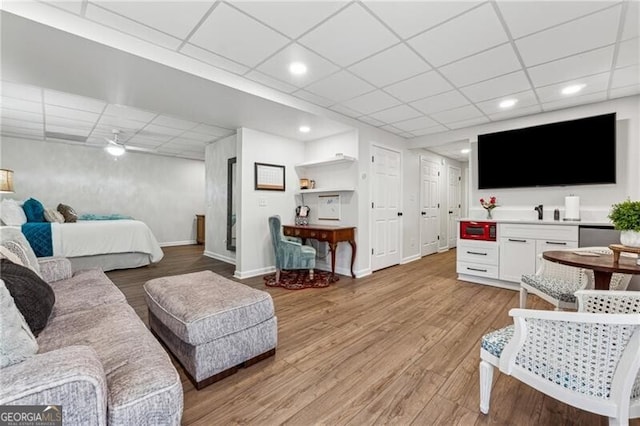 bedroom featuring a paneled ceiling and light hardwood / wood-style floors