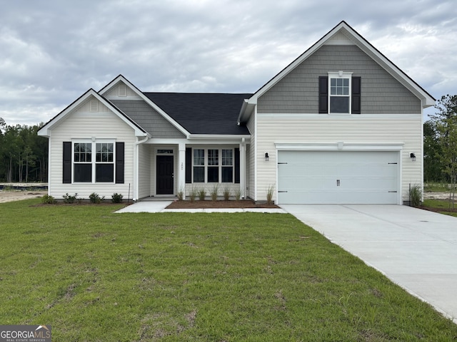 view of front of home featuring concrete driveway, a front yard, and a garage