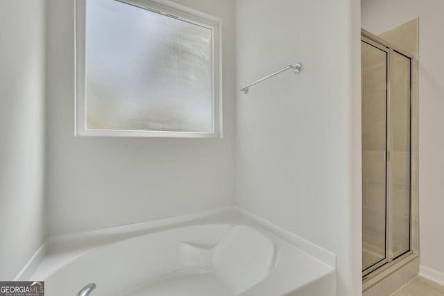 bathroom with separate shower and tub