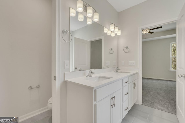 bathroom featuring vanity, tile patterned floors, ceiling fan, and toilet