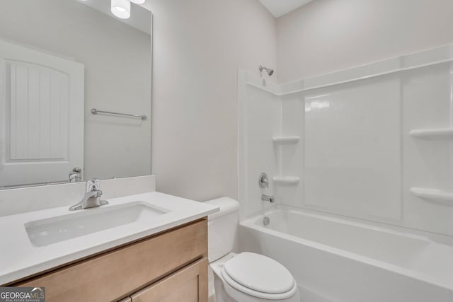 bathroom featuring toilet, vanity, and bathing tub / shower combination