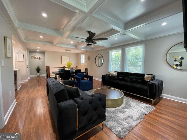 living room featuring coffered ceiling, crown molding, hardwood / wood-style flooring, beamed ceiling, and ceiling fan