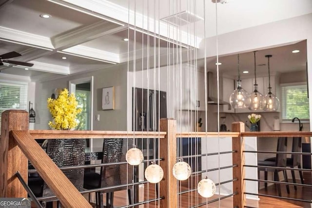 interior space featuring coffered ceiling, beam ceiling, and ornamental molding