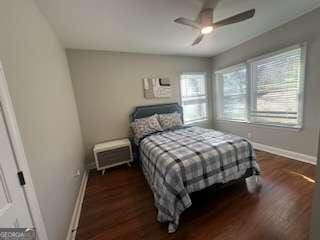 bedroom with dark wood-type flooring and ceiling fan