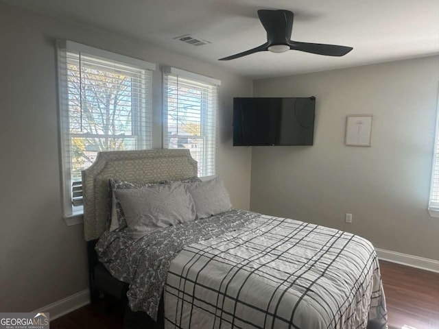 bedroom with dark wood-type flooring and ceiling fan