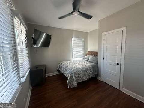 bedroom with dark wood-type flooring and ceiling fan