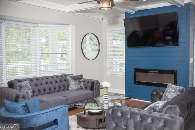 living room with crown molding, a fireplace, ceiling fan, and hardwood / wood-style flooring