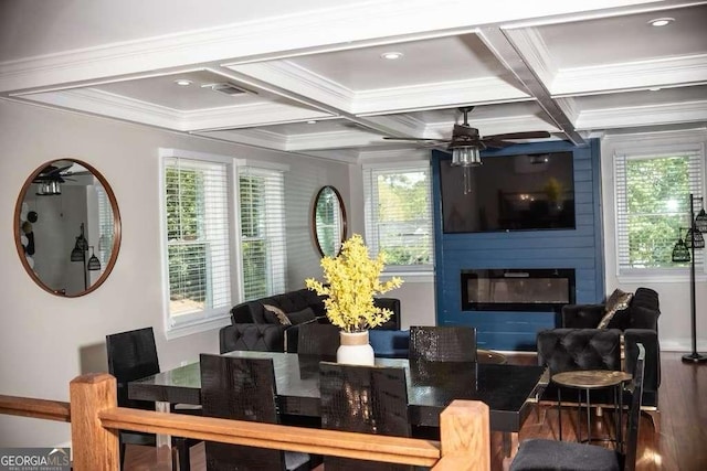 interior space with crown molding, beam ceiling, coffered ceiling, a fireplace, and wood-type flooring