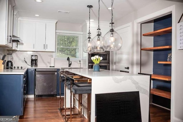 kitchen with white cabinetry, sink, dishwashing machine, hanging light fixtures, and a center island