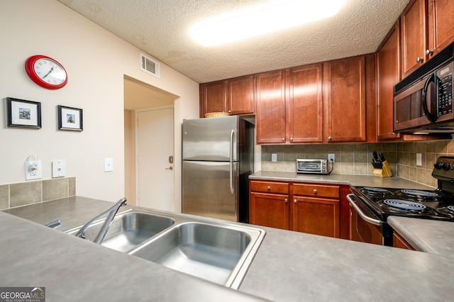 kitchen with stainless steel appliances, sink, backsplash, and a textured ceiling