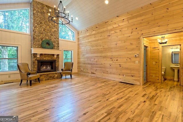 living area with an inviting chandelier, light hardwood / wood-style flooring, and a healthy amount of sunlight