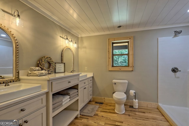 bathroom with wood-type flooring, a shower, wooden ceiling, and vanity