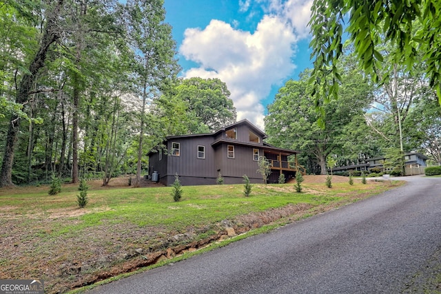 view of side of home with a lawn