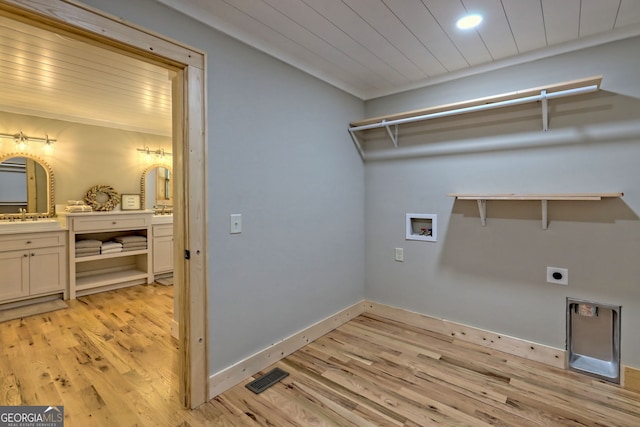 laundry area featuring sink, wood ceiling, light hardwood / wood-style floors, hookup for a washing machine, and electric dryer hookup