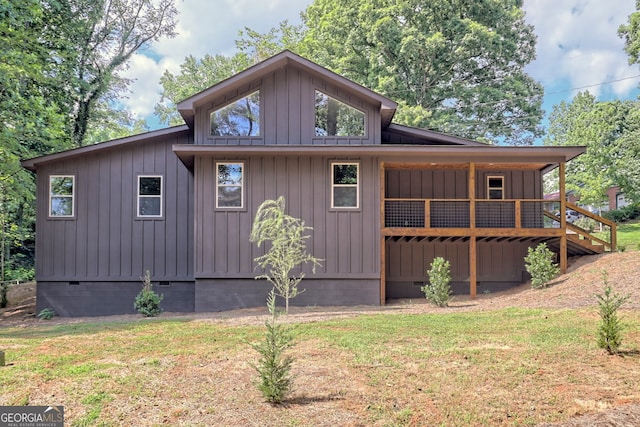 back of house with a lawn