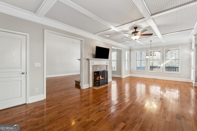 unfurnished living room featuring a tiled fireplace, wood-type flooring, coffered ceiling, and ceiling fan