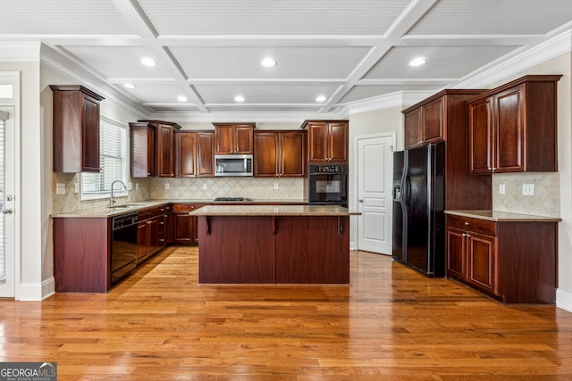 kitchen with sink, coffered ceiling, a center island, light hardwood / wood-style floors, and black appliances