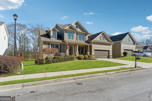 craftsman inspired home featuring a garage, a porch, and a front lawn