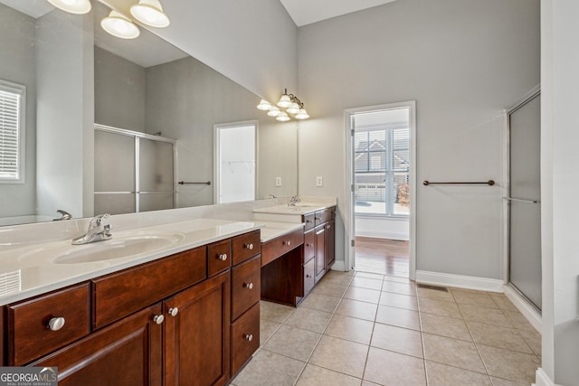 bathroom with tile patterned floors, an enclosed shower, and vanity