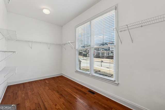 walk in closet with hardwood / wood-style floors