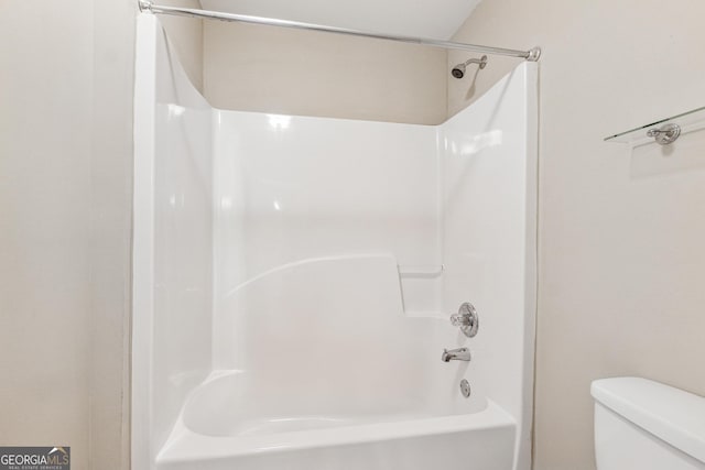 bathroom featuring bathing tub / shower combination and toilet