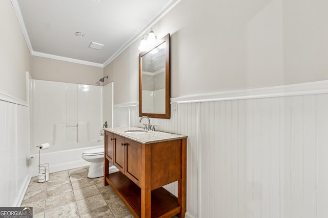 full bathroom featuring ornamental molding, vanity, washtub / shower combination, and toilet