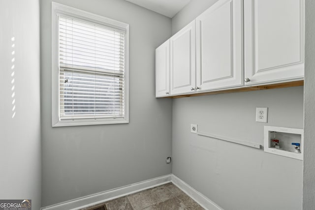 washroom with cabinets, hookup for an electric dryer, and hookup for a washing machine