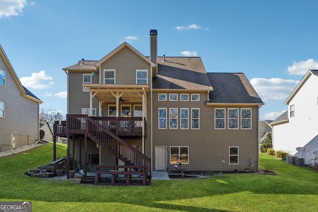 rear view of property featuring a wooden deck, ceiling fan, a lawn, and cooling unit