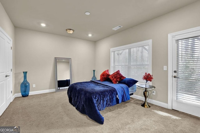 bedroom featuring light carpet and access to exterior