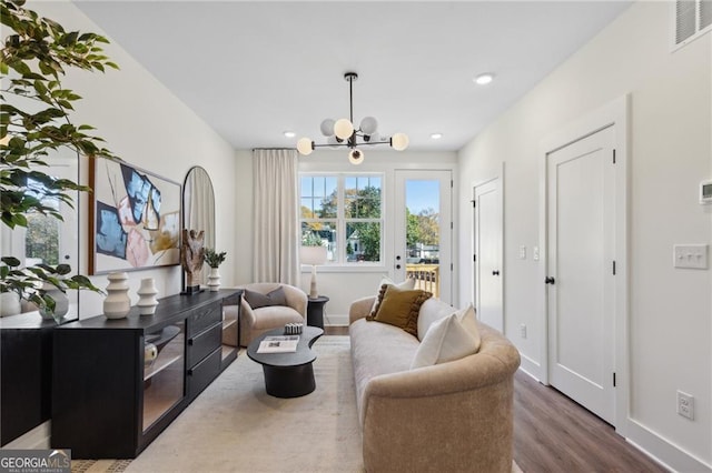 sitting room featuring dark hardwood / wood-style floors and an inviting chandelier