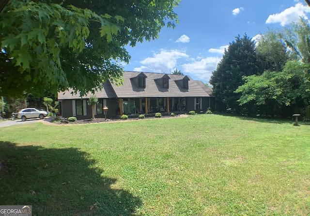 new england style home featuring a front lawn