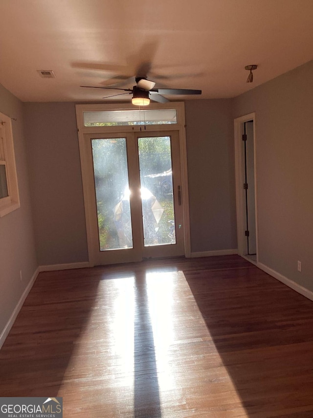 empty room with hardwood / wood-style flooring and ceiling fan