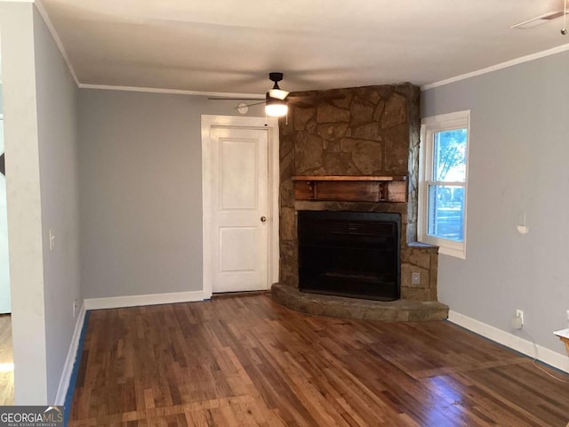 unfurnished living room with ornamental molding, dark hardwood / wood-style flooring, a fireplace, and ceiling fan