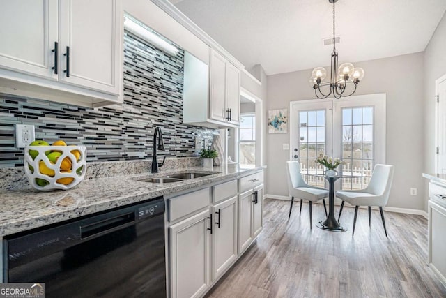 kitchen featuring black dishwasher, sink, white cabinets, and light hardwood / wood-style floors